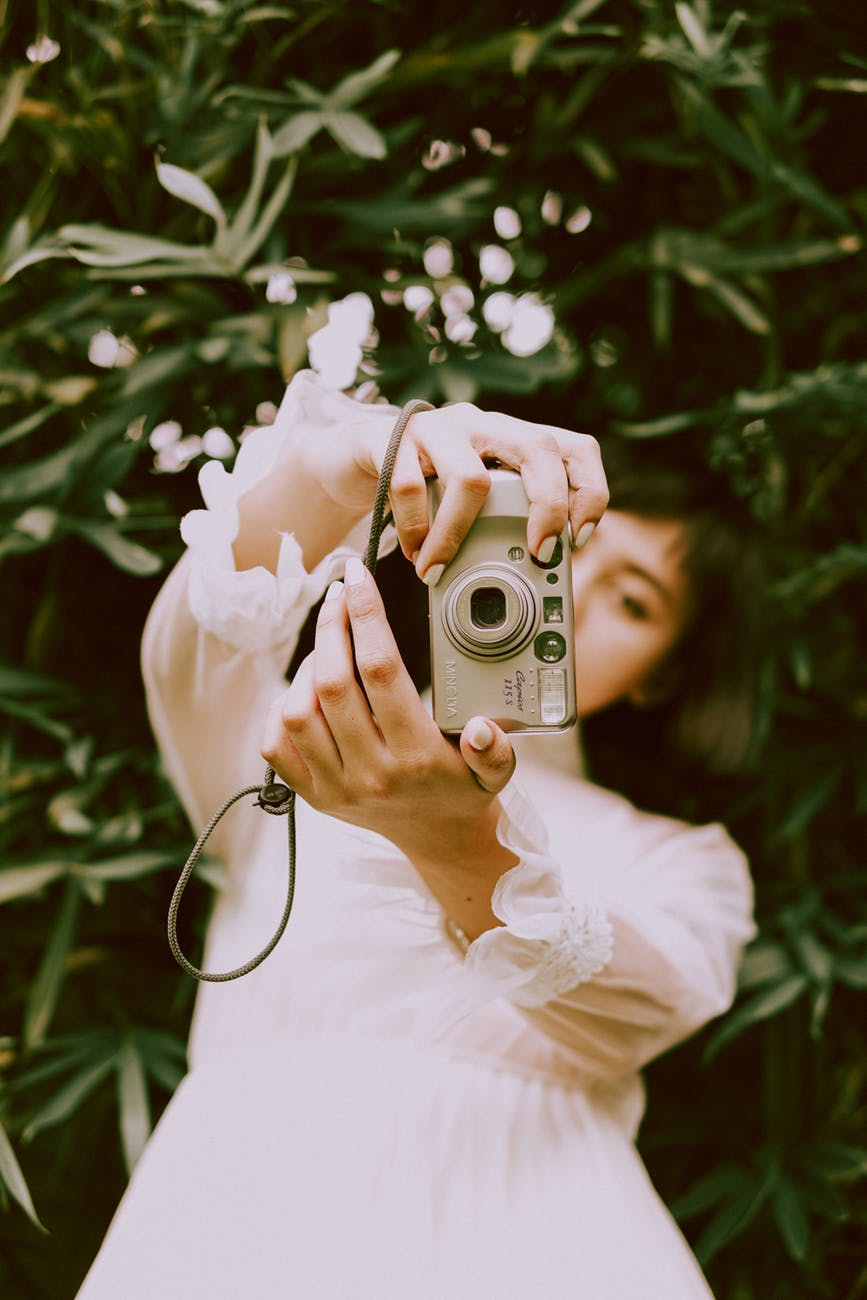photo of woman holding camera